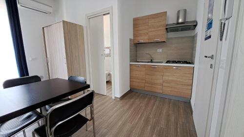 a small kitchen with a table and a counter top at Le Due Sicilie B&B in Lascari
