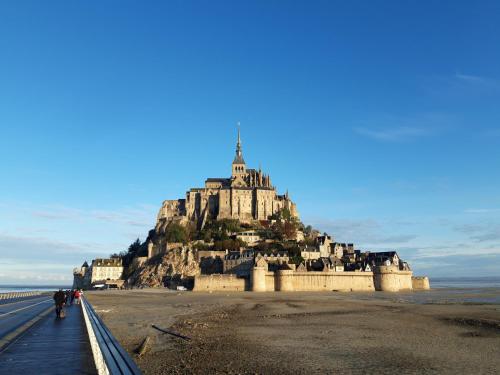 a castle on top of an island on the beach at Superbe Maison en baie du Mont St Michel in Vains