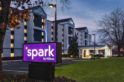 a sign in front of a building with a parking lot at Spark By Hilton Germantown Washington Dc North in Germantown