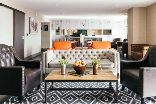a living room with a couch and a table at Whitney Peak Hotel Reno, Tapestry Collection by Hilton in Reno