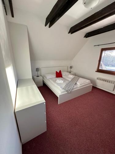 sypialnia z 2 łóżkami i czerwonym dywanem w obiekcie Chalúpka Bratov v resorte APLEND w Sławkowie Wielkim