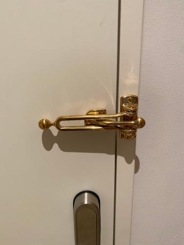 a gold door handle on a white door at CPH Like Home in Copenhagen
