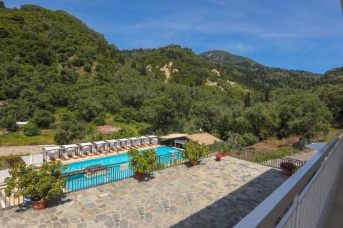 a swimming pool with a view of a mountain at Marina Apartments, Agios Gordios Corfu in Agios Gordios