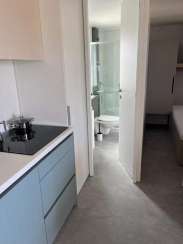 a white kitchen with a sink and a toilet at SUN&MOON in Drage