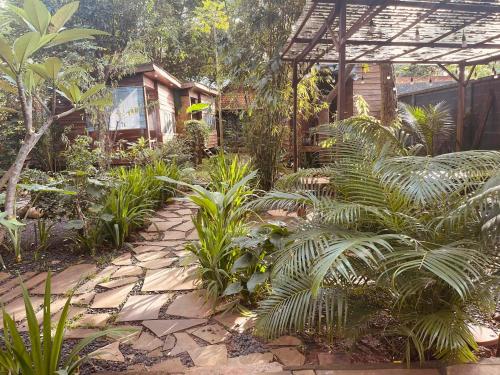 a garden with plants and a stone walkway at Gỗ Homestay khu sinh thái Akodhong và trung tâm BMT in Buon Ma Thuot