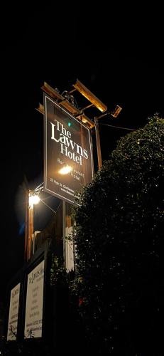 a large sign for a hotel at night at The Lawns Hotel in Derby