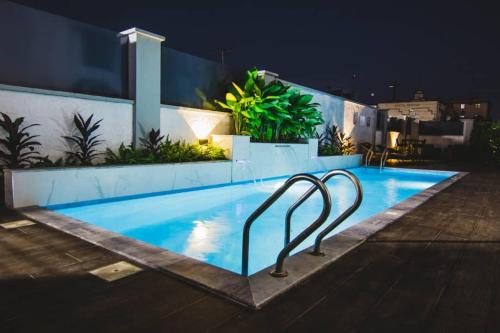 a swimming pool at night with at BON Hotel Lekki Residence in Lagos