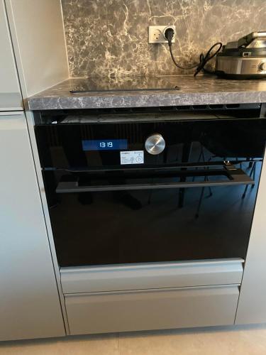 a black dishwasher in a kitchen with a counter at CPH Like Home in Copenhagen