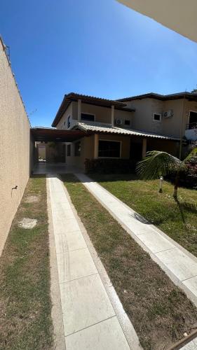 a walkway in front of a house at Recanto Ville House in Porto Seguro