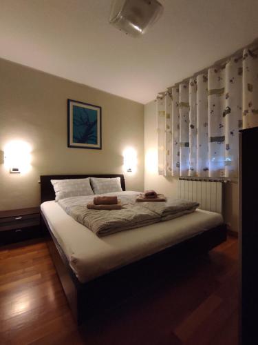 a bedroom with a bed with two towels on it at Apartma Laura in Ankaran