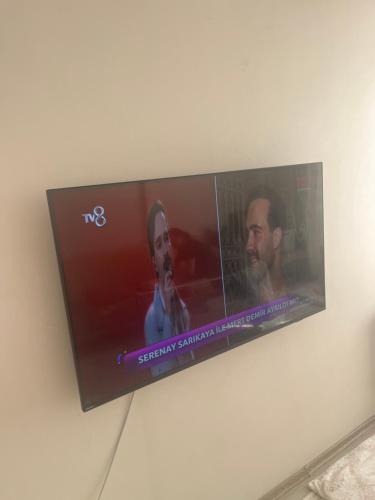 a flat screen tv hanging on a wall at Weltek in Güllüce