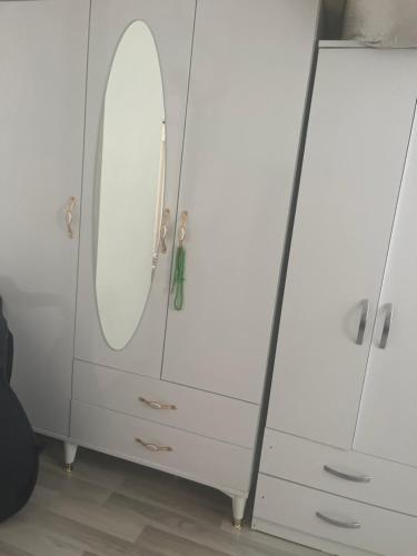 a white dresser with a mirror on it at Weltek in Güllüce
