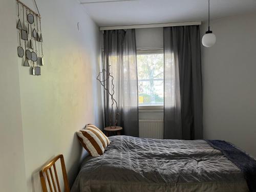 a bedroom with a bed and a window at Central 2 Br in Tampere