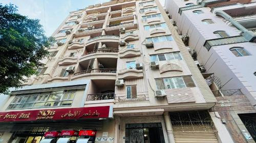 a tall building with balconies on the side of it at luxurious apartment in Az Zaqāzīq