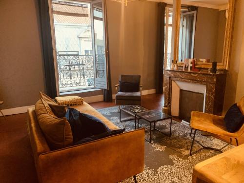 a living room with couches and a fire place at Casa Roma Montpellier Bed&Breakfast chambres d hôte in Montpellier