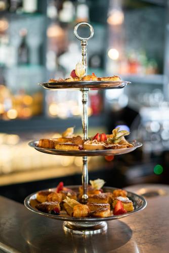 a three tiered plate of food on a table at Mirabeau Etoile in Zermatt