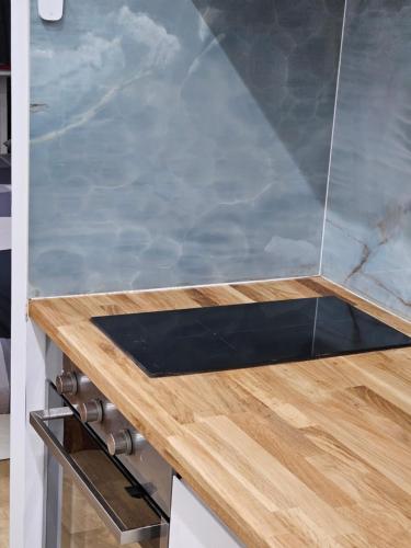 a kitchen with a counter top with a wooden counter top at Lovely appartement near sea and Monaco with free parking in Roquebrune-Cap-Martin