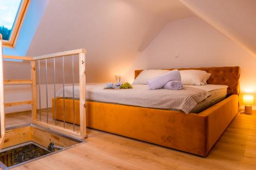 a bedroom with a bed in a attic at Dusznickie Apartamenty Julia in Duszniki Zdrój