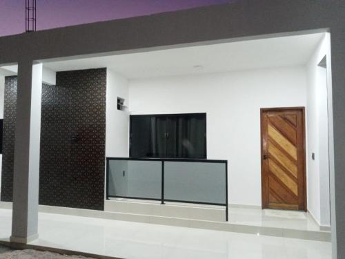 a living room with a flat screen tv on a wall at VR Flats in Maragogi