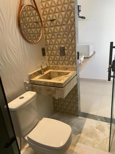 een badkamer met een toilet en een wastafel bij VR Flats in Maragogi