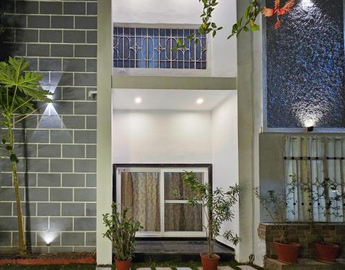 a house with a window and plants in front of it at Green Villa in Udaipur