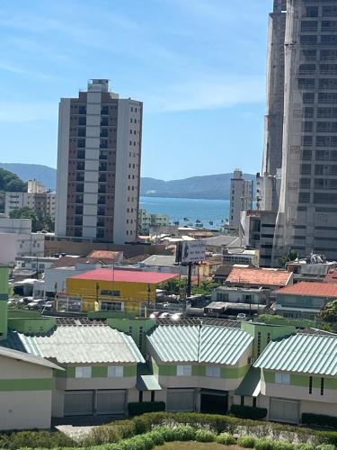 a view of a city with buildings and the ocean at Condomínio Vista Atlântico - Apartamento Novo - Próximo à Praia - Vista Mar - Área de Lazer in Itapema