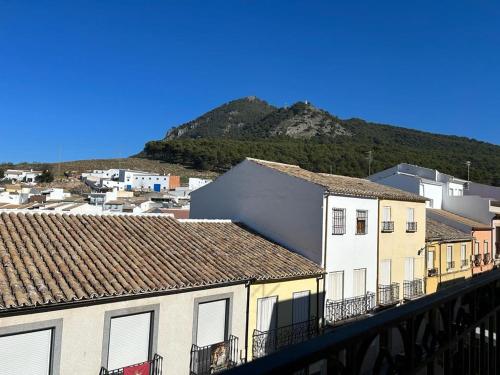 a group of buildings with a mountain in the background at Casa Ancá Los Abuelos in Rute