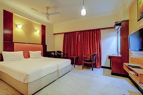 a hotel room with a bed and a television at Palette - Chennai Deluxe Koyambedu in Chennai