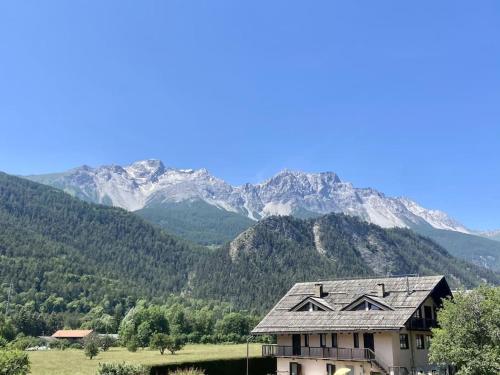 a house in front of a mountain with mountains at deer house in Savoulx