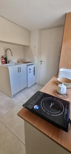 a kitchen with a laptop sitting on a counter at studio apartment in Naẕerat ‘Illit