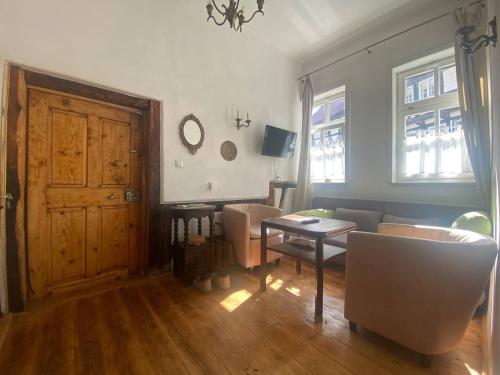 a living room with a couch and a table at Haus Anastasia in Stolberg i. Harz