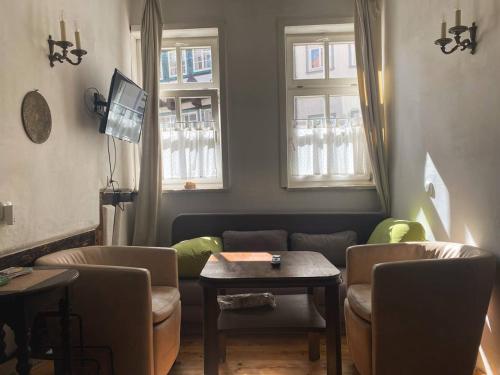 a living room with a couch and a table at Haus Anastasia in Stolberg i. Harz