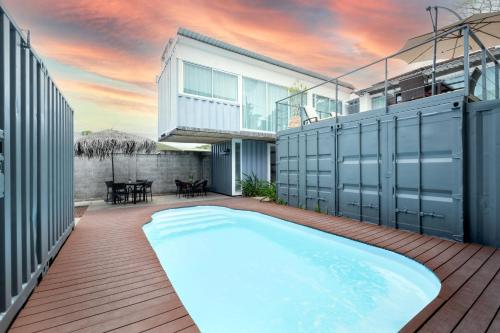 a swimming pool in the backyard of a house at Hotel Bamboo in Jacó
