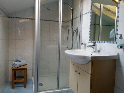 a bathroom with a sink and a shower at Appartements Kirchtalhof in Lana