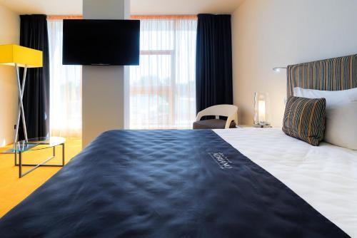  Кровать или кровати в номере Бутик Отель Адриано 