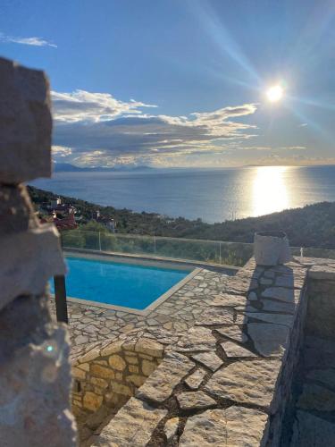 a swimming pool with a view of the ocean at Apollo Romantic Sea View Villa in Kivérion