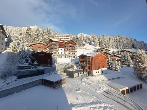 a resort in the mountains covered in snow at Ferienwohnung Parsenn Peaks Panorama in Davos