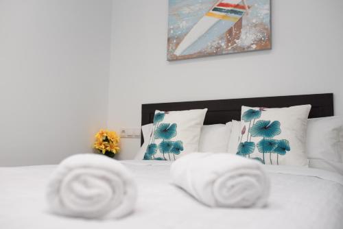 a white bed with white sheets and pillows at AYZ Luis Cabrera-Auto check-in property in Madrid