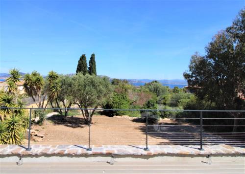 a view of a park with trees and a fence at La madrague-Villa/Piscine vue Mer/Clim/Wifi in Hyères