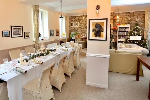 a long dining room with a long table and chairs at Ty Croeso House in Llangattock