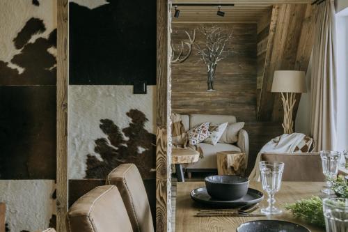 a living room with a table and a couch at Luxury Chalet Kajmer in Jurgów