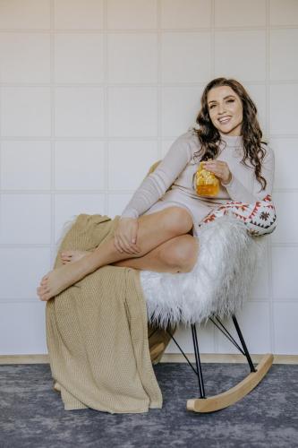 a woman sitting on a chair with a bowl of food at Luxury Chalet Kajmer in Jurgów