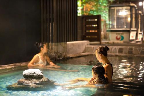 a group of people in a swimming pool at Ryokan Sakaya in Nozawa Onsen