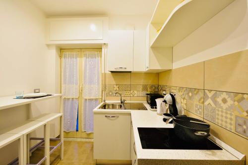 a small kitchen with a sink and a counter at Floral Holiday in Minori