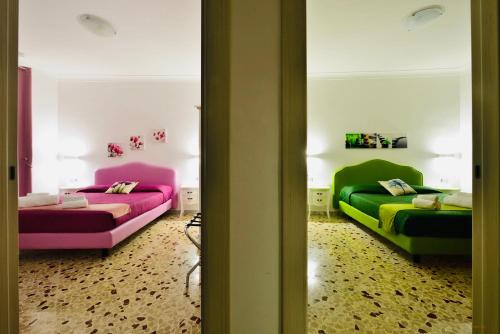 two beds in a room with colorful at Floral Holiday in Minori