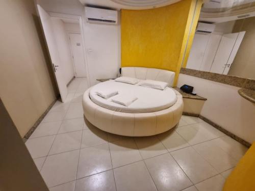 a room with a large white bed in a room at Fantasy Motel in Salvador