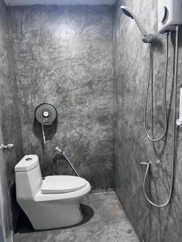a bathroom with a toilet and a shower at Say My Name in Koh Phangan