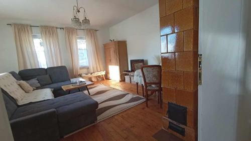 a living room with a couch and a table at Rodinná chata v rekreačnej oblasti DRIENICA in Sabinov