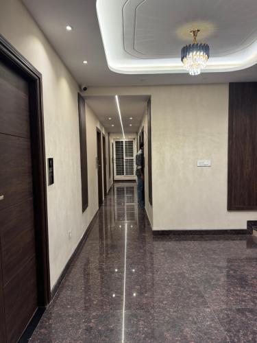 a man standing in a hallway of a building at S K Legacy Hotel in Mysore