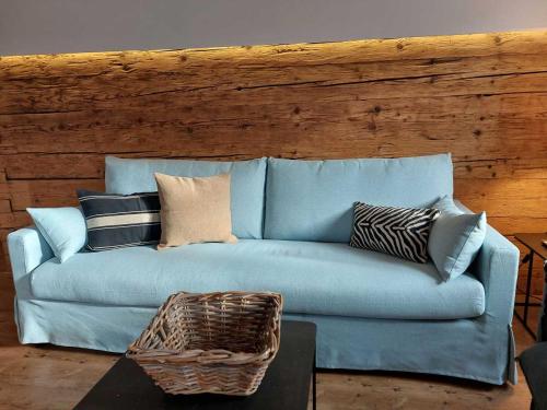 a blue couch with pillows in a living room at Ferienwohnungen Beargzit in Bad Hindelang